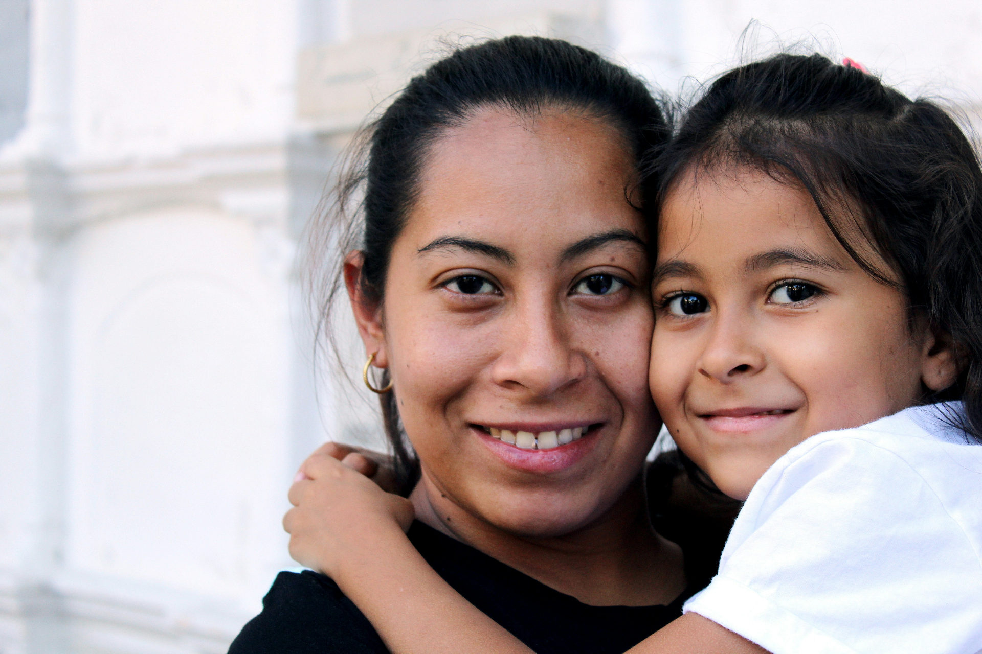 A mother and two children hold the keys to their new home